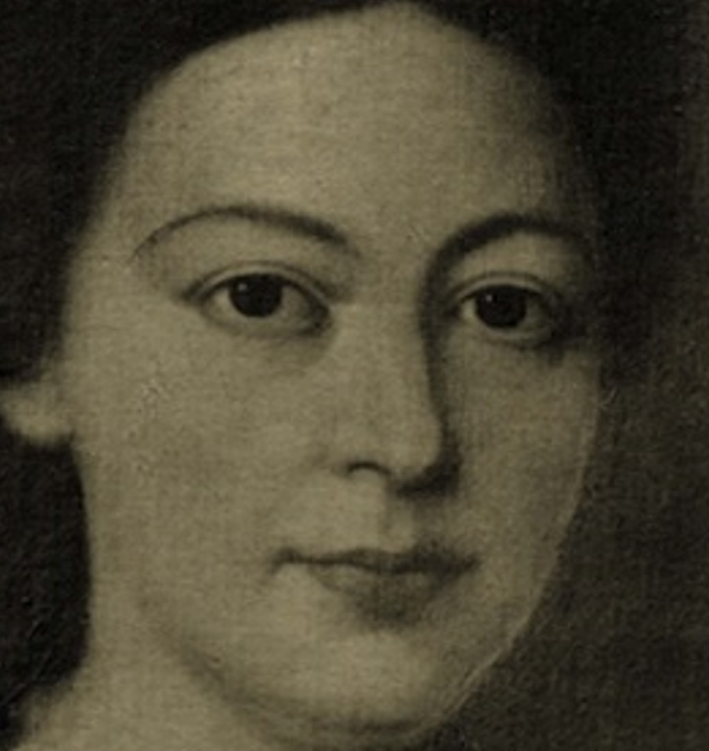 zdjęcie w sepii przedstawiające twarz kobiety o ciemnych włosach